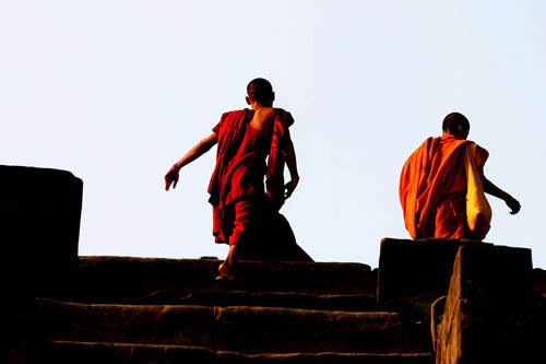 monks climbing at sunrise
